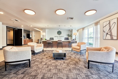 a living room with couches and chairs and a bar in the corner